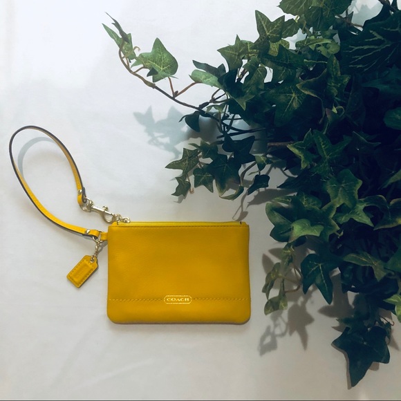 Coach Handbags - BRAND NEW Yellow coach clutch/wristlet
